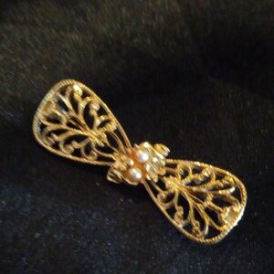 Made by 1928.Elegant Gold Filigree Bow Brooch with pearl accent.